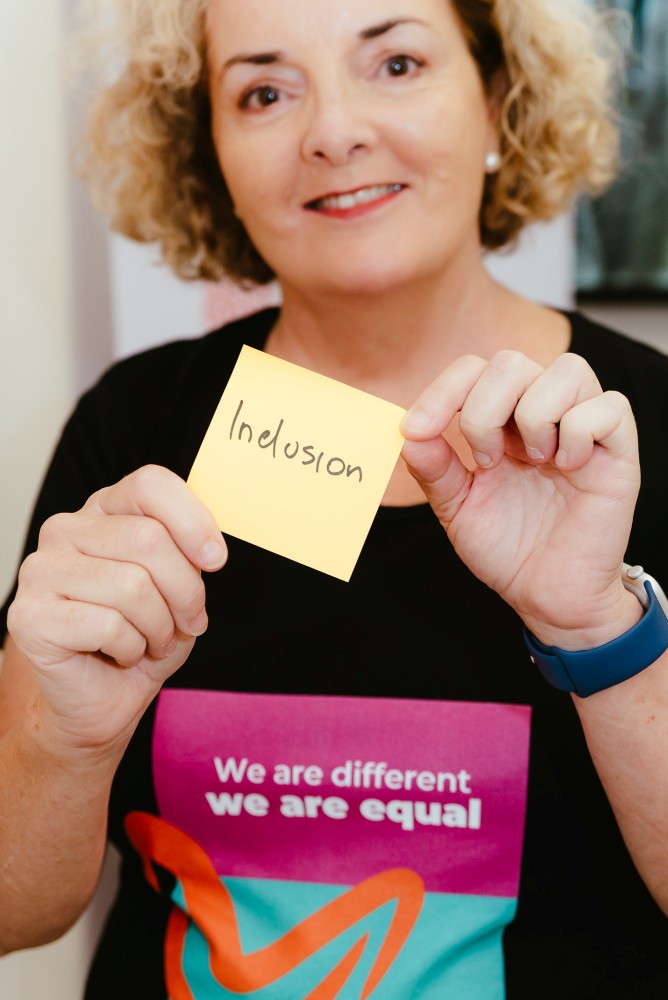 Brisbane Branding Photography holding sticky note saying inclusion