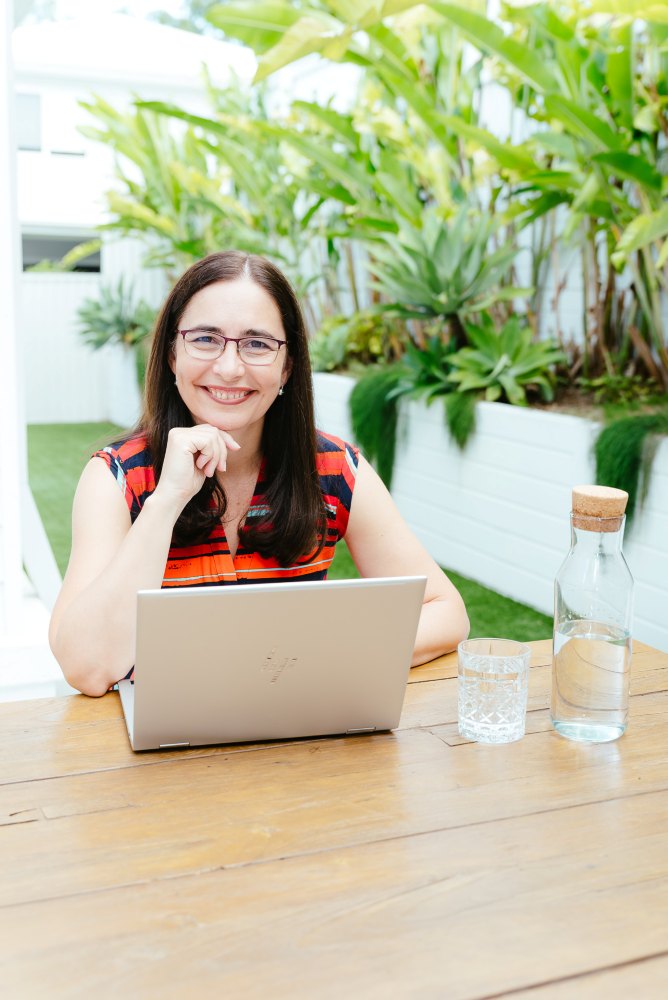 Brisbane Branding Photographer Kylie Hayes Coach working on laptop sitting outside
