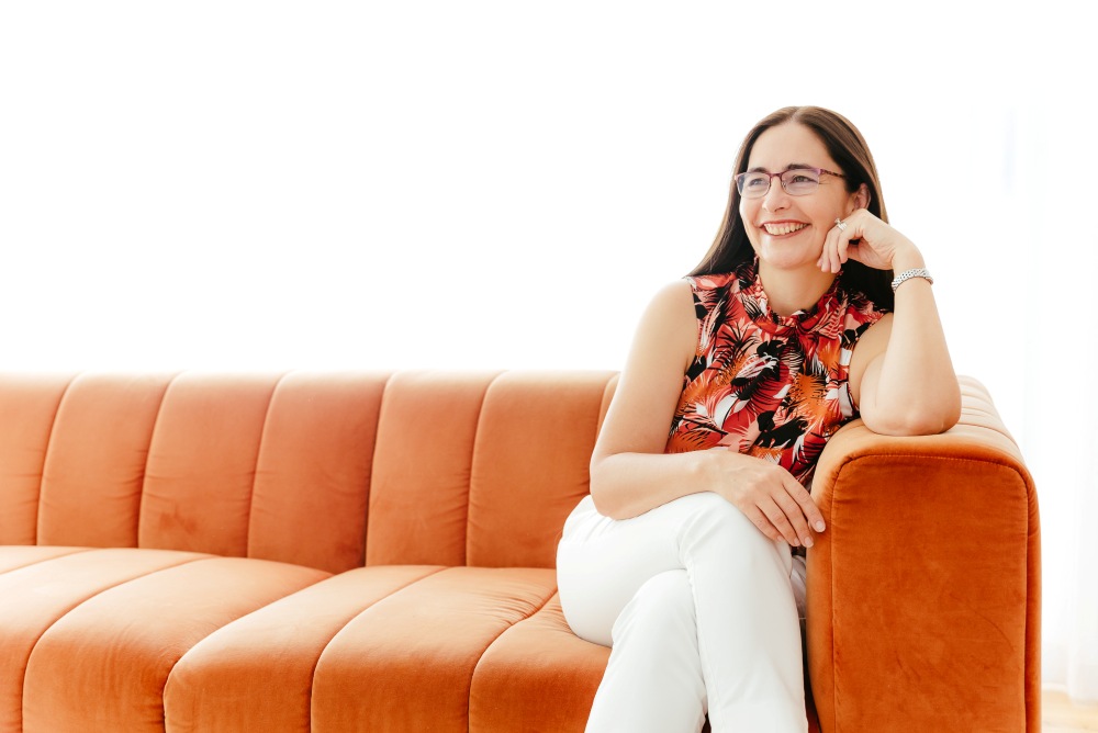 Brisbane Branding Photographer Kylie Hayes Coach Sitting on orange couch looking away to the side
